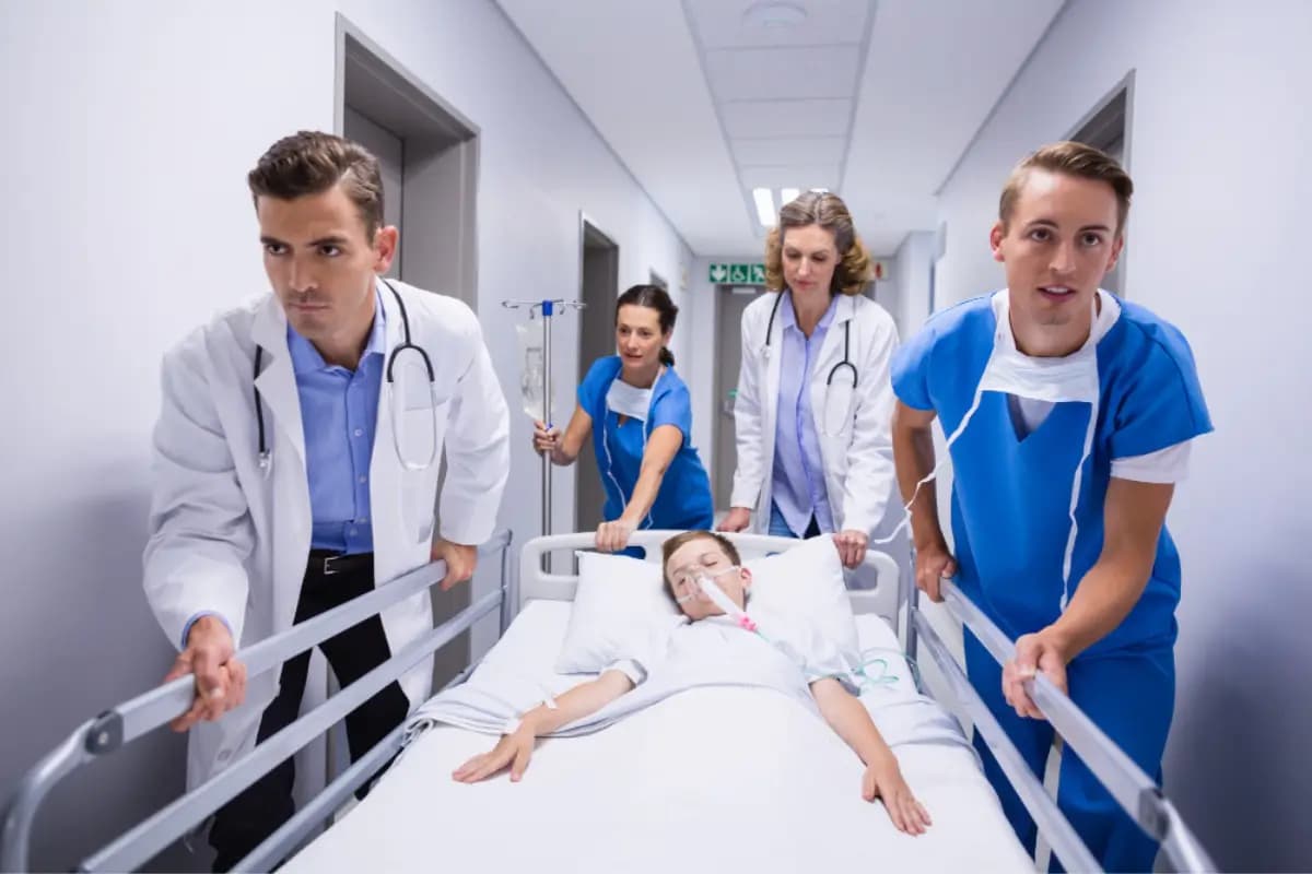 Emergency care team transporting a patient through a hospital