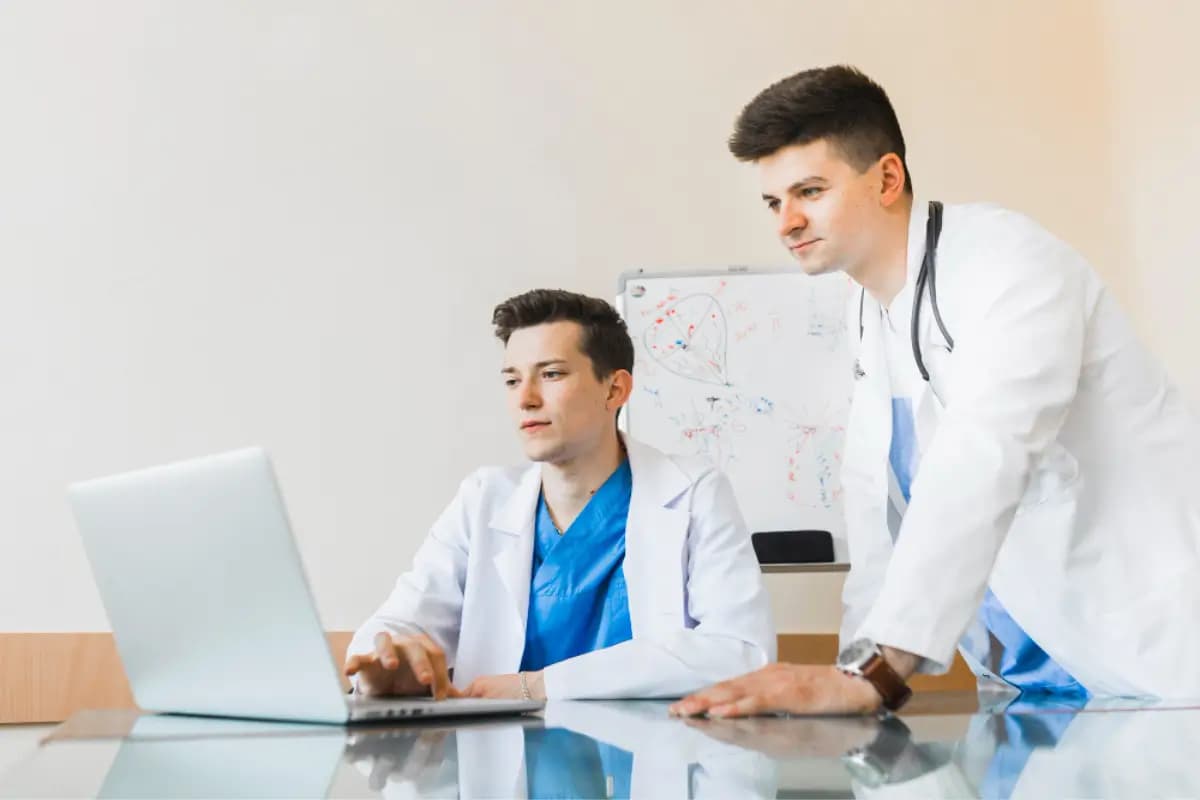 Healthcare professionals reviewing documentation together at a computer